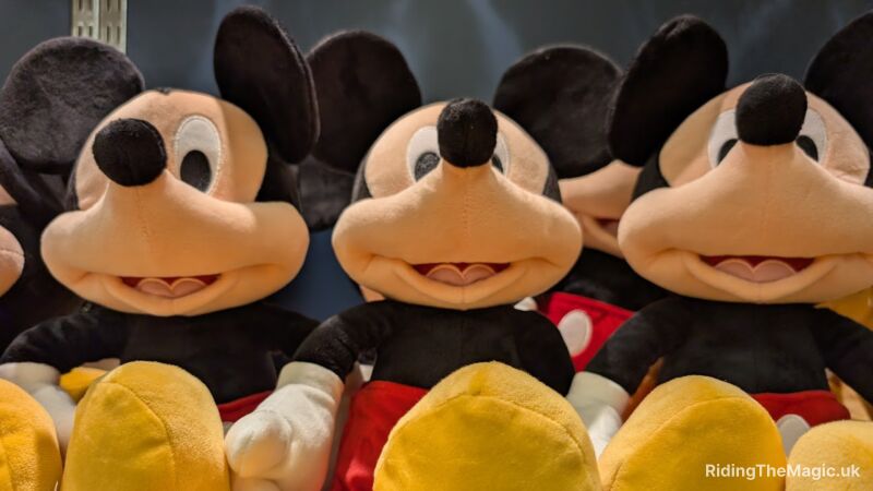 Mickey Mouse plush toys are lined up in a row