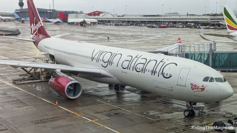 A Virgin Atlantic airplane is parked on the tarmac at an airport